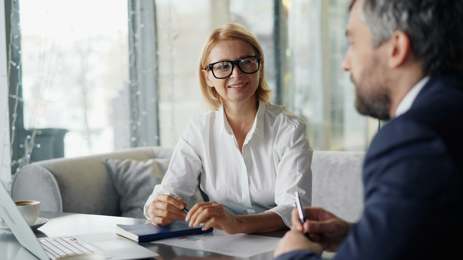 A planner talking with a client across a desk
