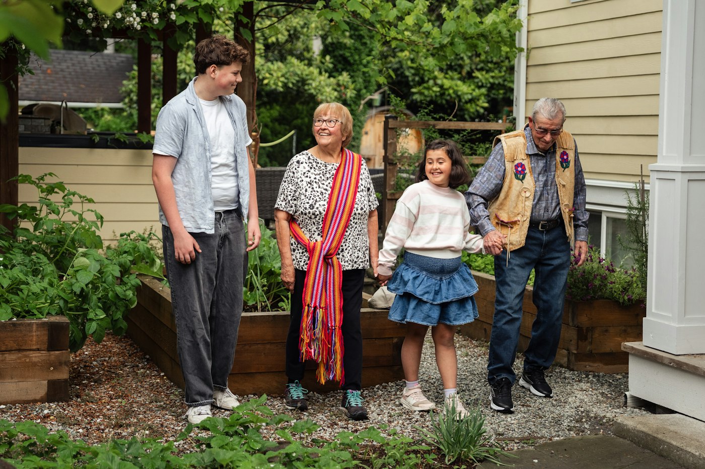 A family standing together outside their house