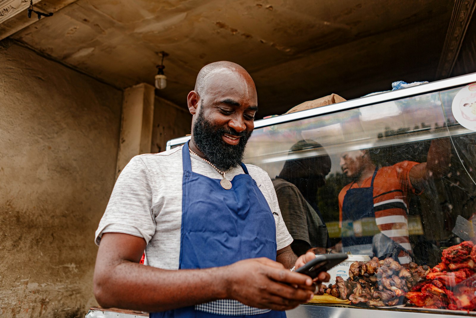 A restaurant owner in an apron checking an order