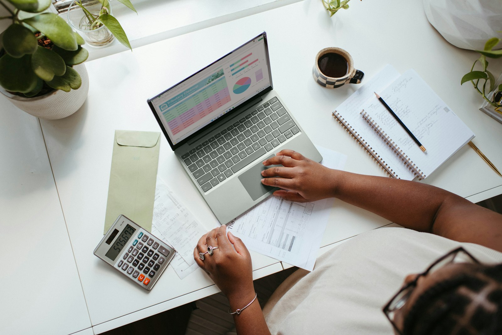 Planning papers, a laptop and a calculator on a desk