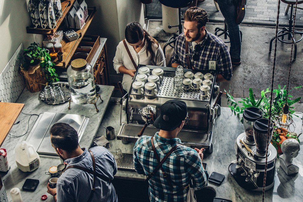 Staff at work behind a busy cafe counter
